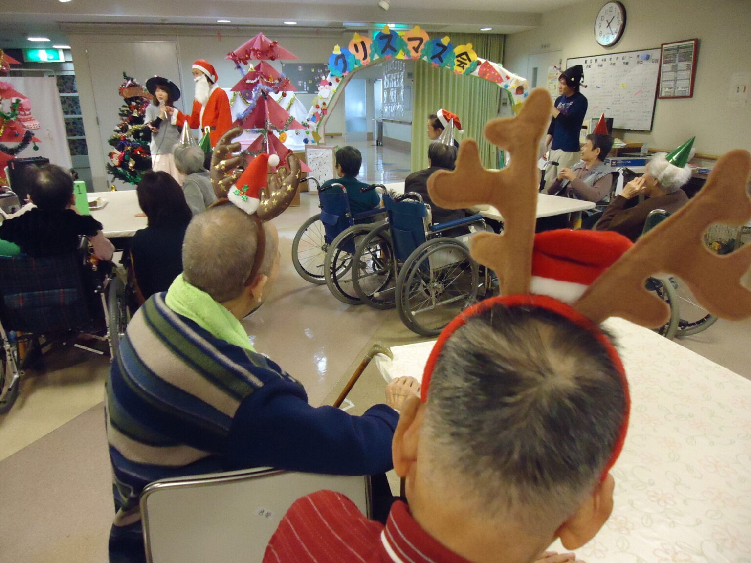 クリスマスイベント中の共用スペース。入居者がクリスマスデコレーションを楽しんでいる光景。